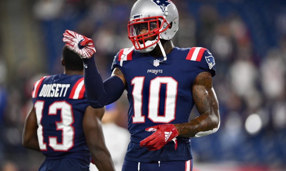 New England Patriots wide receiver Josh Gordon (10) gets a hug from  quarterback Tom Brady after the two connected for a touchdown reception in  the third quarter against the Minnesota Vikings at